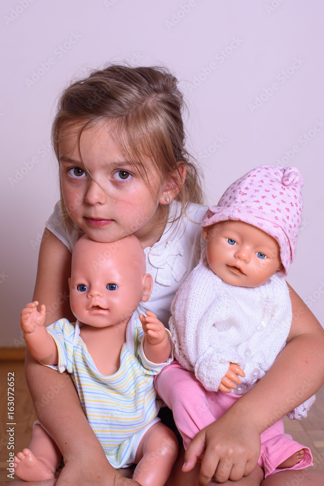little girl play with newborn dolls little girl play with newborn dolls