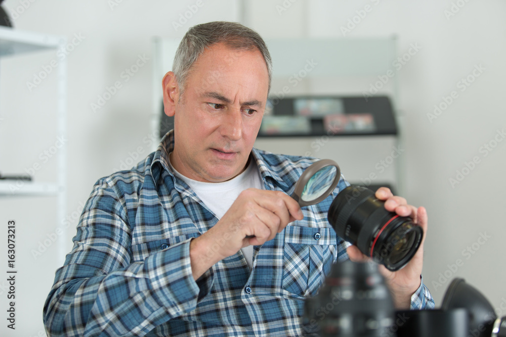 photographer checking problem on his camera photographer checking problem on his camera