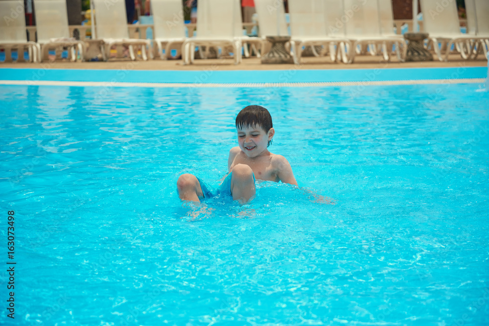 Smiling boy in the pool.