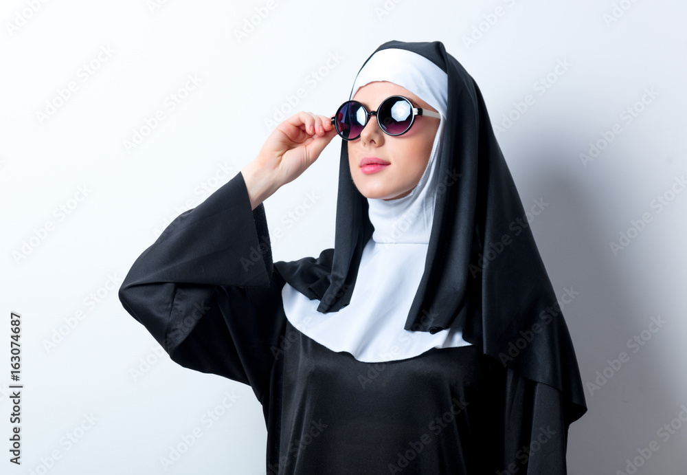 Young serious nun with sunglasses Young serious nun with sunglasses