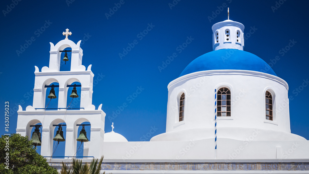 Oia town on Santorini island, Greece. Traditional and famous houses and churches with blue domes over the Caldera, Aegean sea Oia town on Santorini island, Greece. Traditional and famous houses and churches with blue domes over the Caldera, Aegean sea