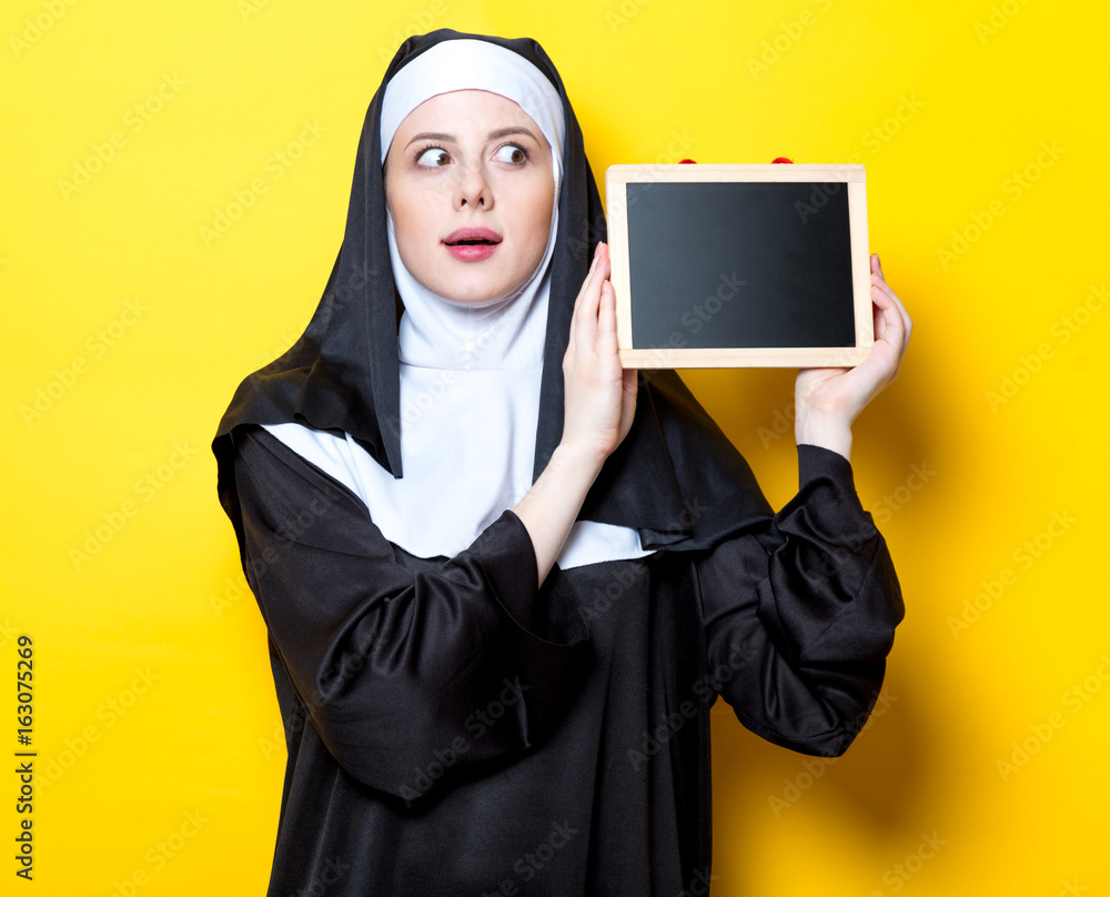 Young surprised nun with board Young surprised nun with board