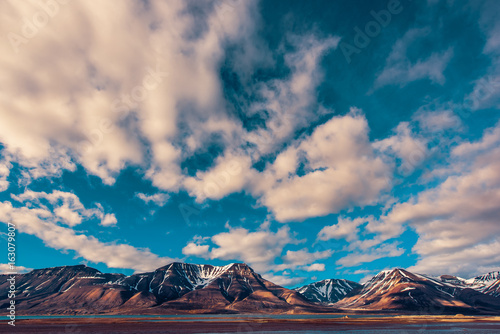 Wallpaper norway landscape nature of the mountains of Spitsbergen Longyearbyen Svalbard on a polar day with blue sky and clouds in the sunset summer