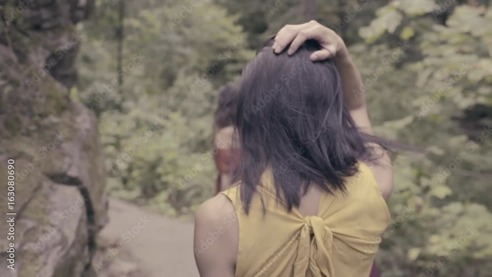 3 Beautiful Models Walk In Forest, Away From Camera, Model Looks Back Over Her Shoulder (Slow Motion) 3 Beautiful Models Walk In Forest, Away From Camera, Model Looks Back Over Her Shoulder (Slow Motion)