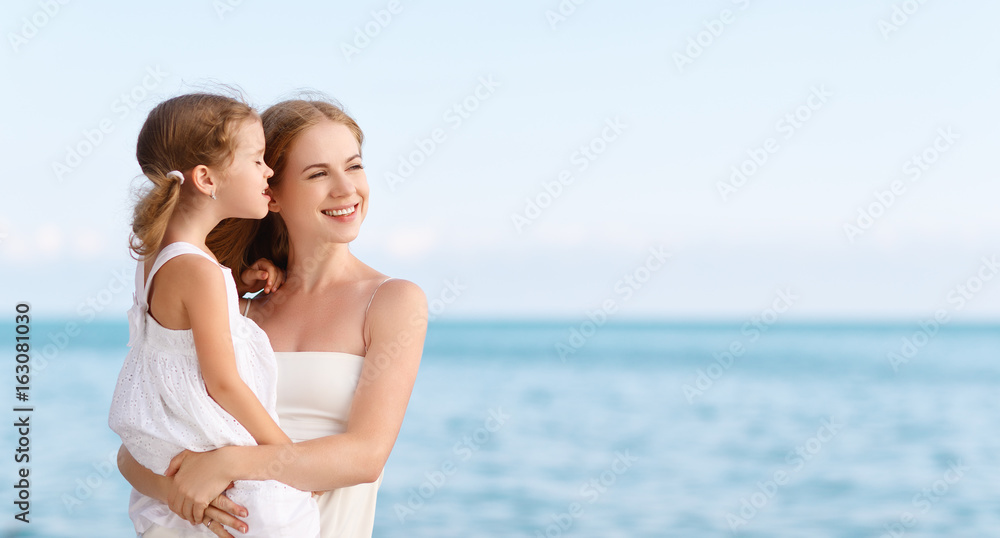 happy family at beach. mother hugging child daughter