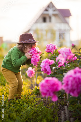 Toddler girl with peonys