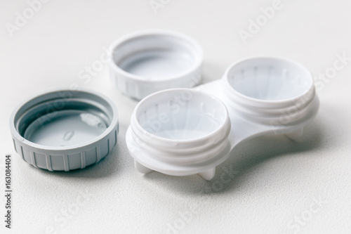 Open contact lens case or container on white background