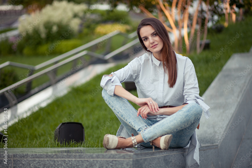 dreamy young attractive woman sitting in contemporary green park dreamy young attractive woman sitting in contemporary green park