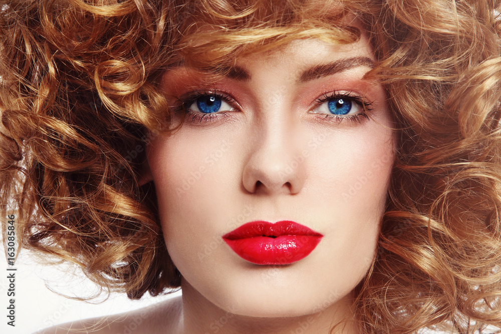 Close-up portrait of young beautiful blue-eyed woman with curly hair Close-up portrait of young beautiful blue-eyed woman with curly hair