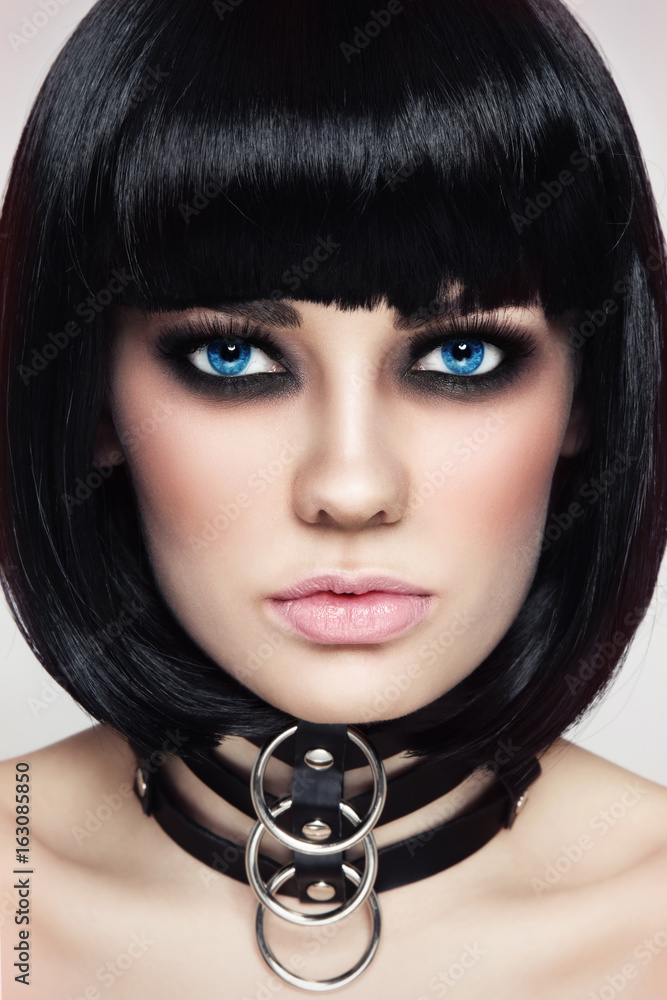 Close-up portrait of young beautiful sexy brunette in black leather collar Close-up portrait of young beautiful sexy brunette in black leather collar