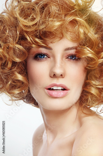 Vintage style portrait of young beautiful sexy woman with curly hair