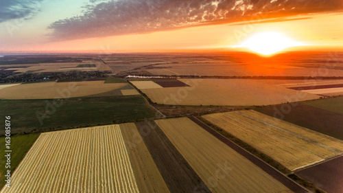 Aerial shot of an agricultural field at a splendid sunset in Eastern Europe