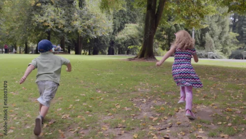 Happy Brother And Sister Jump Off Picnic Table And Run Around Park (Slow Motion) Happy Brother And Sister Jump Off Picnic Table And Run Around Park (Slow Motion)