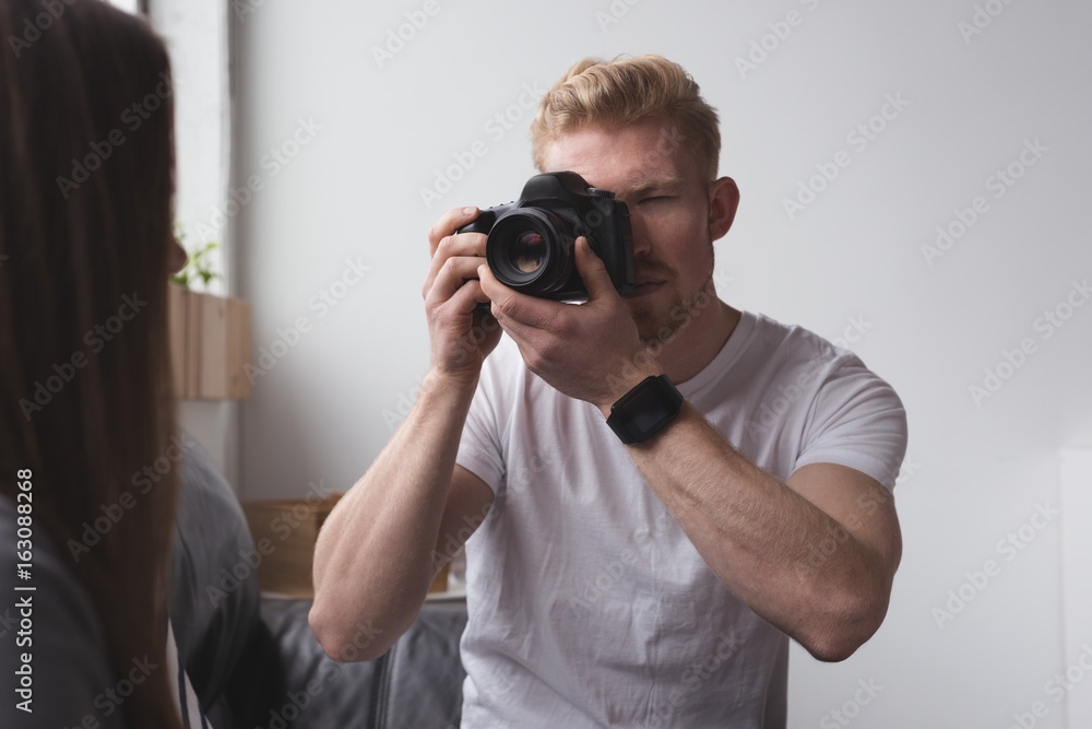Male photographer photographing model Male photographer photographing model