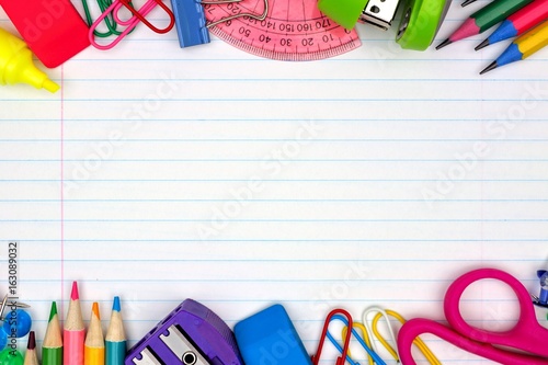 Colorful school supplies double border over a lined paper background