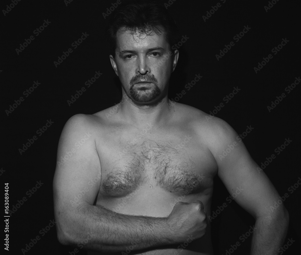 Muscular man showing his muscles Muscular man showing his muscles