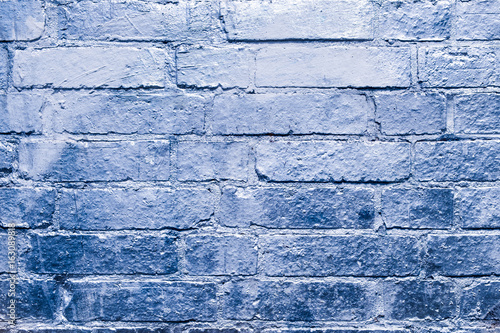 brick  wall with blue, silver colored paint photo