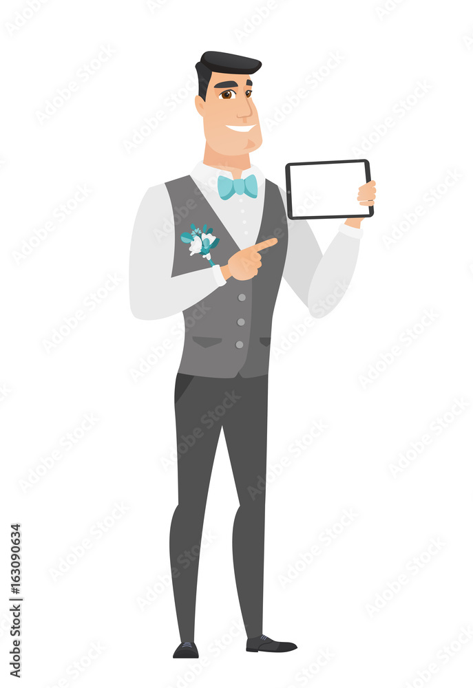 Smiling groom holding tablet computer.