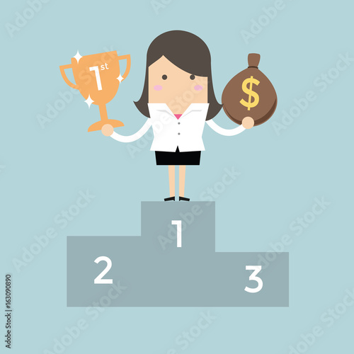 Businesswoman standing on the winning podium holding trophy and a bag of money