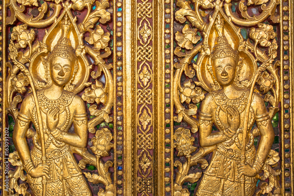 Beautiful golden carving on the door of Wat Sensoukharam temple in Luang Prabang, Laos Beautiful golden carving on the door of Wat Sensoukharam temple in Luang Prabang, Laos
