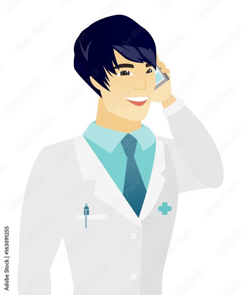 Young asian doctor talking on a mobile phone. Young asian doctor talking on a mobile phone.