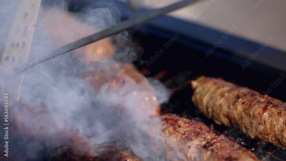 Cooking delicious juicy meat steaks on the grill on fire Cooking delicious juicy meat steaks on the grill on fire