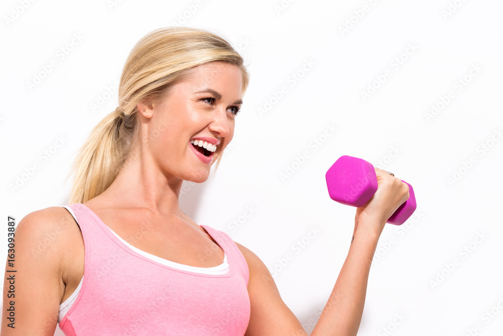 Happy young woman working out with dumbbell Happy young woman working out with dumbbell