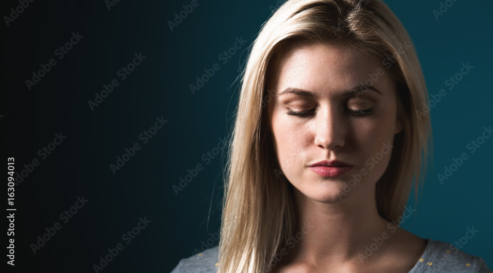 Portrait of a young woman on a dark blue background Portrait of a young woman on a dark blue background