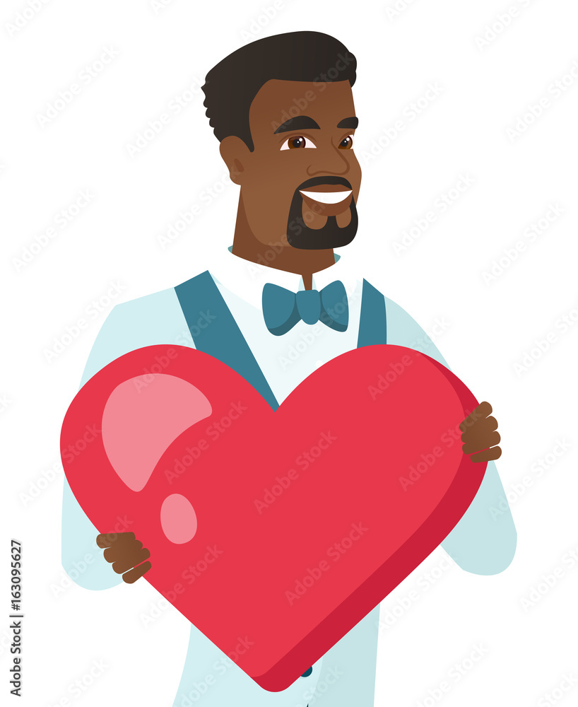 Young african-american groom holding a big heart. Young african-american groom holding a big heart.