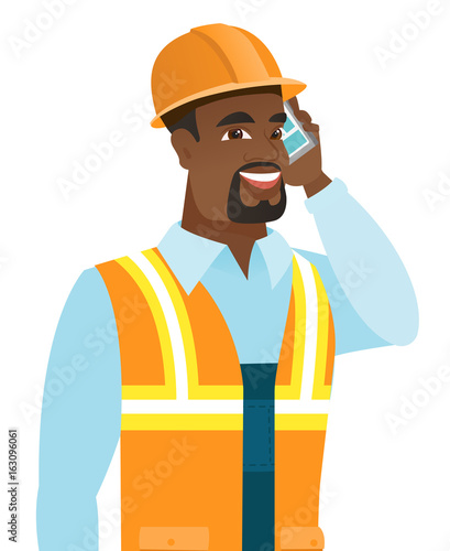 African-american builder talking on mobile phone.