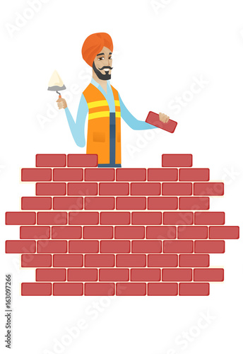 Hindu bricklayer working with spatula and brick.