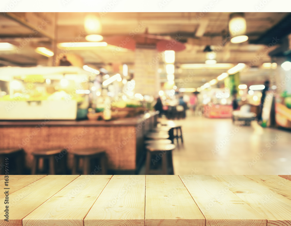 Interior of shopping mall, shopping center or store at indoor plaza blurred background consist of table, people at Chiang Mai of Thailand. Include empty wooden counter or desk for product display. Interior of shopping mall, shopping center or store at indoor plaza blurred background consist of table, people at Chiang Mai of Thailand. Include empty wooden counter or desk for product display.