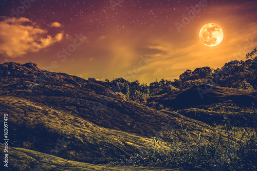 Landscape of sky with many stars and beautiful full moon. Sepia tone. © kdshutterman