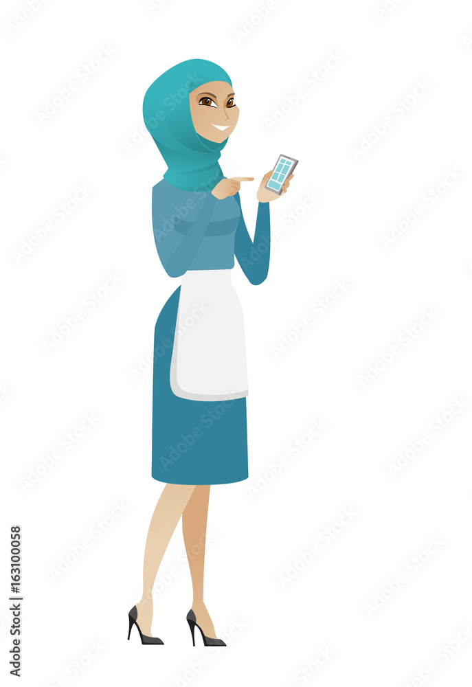 Young muslim cleaner holding a mobile phone. Young muslim cleaner holding a mobile phone.