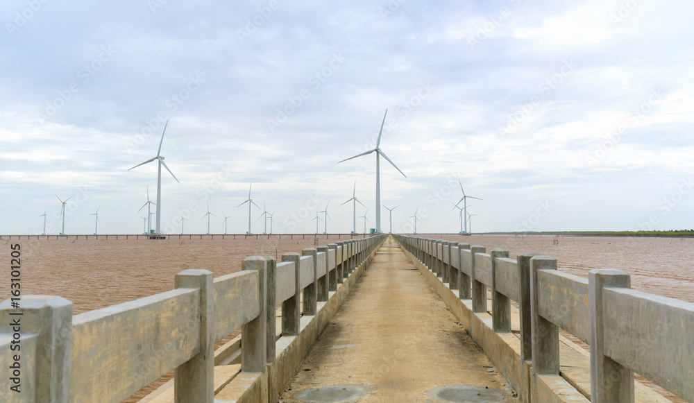Clean energy, wind power plant with a pathway to the giant wind turbines at sea to provide electricity for human life. Clean energy, wind power plant with a pathway to the giant wind turbines at sea to provide electricity for human life.