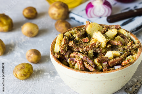 Bavarian salad with smoked meat on a light background