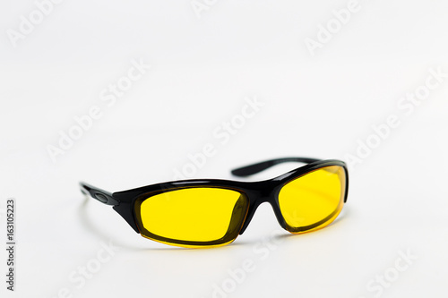 Sunglasses with yellow lenses on a white background