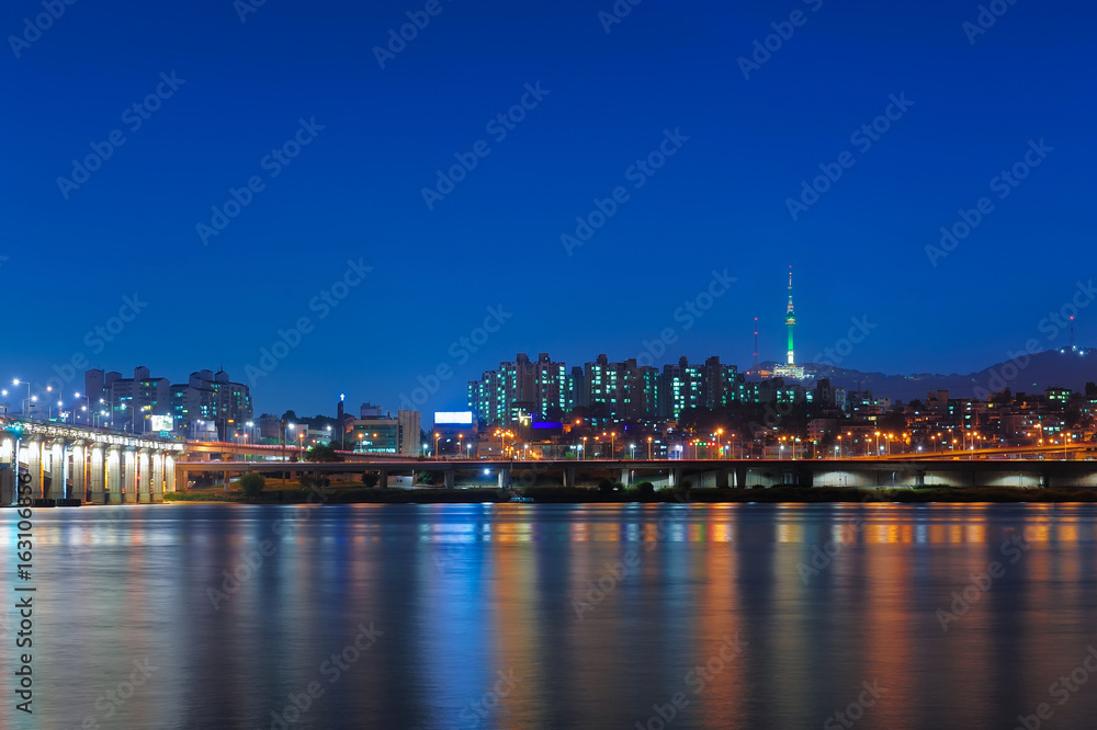 Beautiful landscape view of Namsan mountain with N seoul tower from han river and banpo bridge in twilight time at seoul, south korea