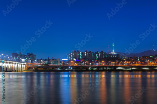Beautiful landscape view of Namsan mountain with N seoul tower from han river and banpo bridge in twilight time at seoul, south korea