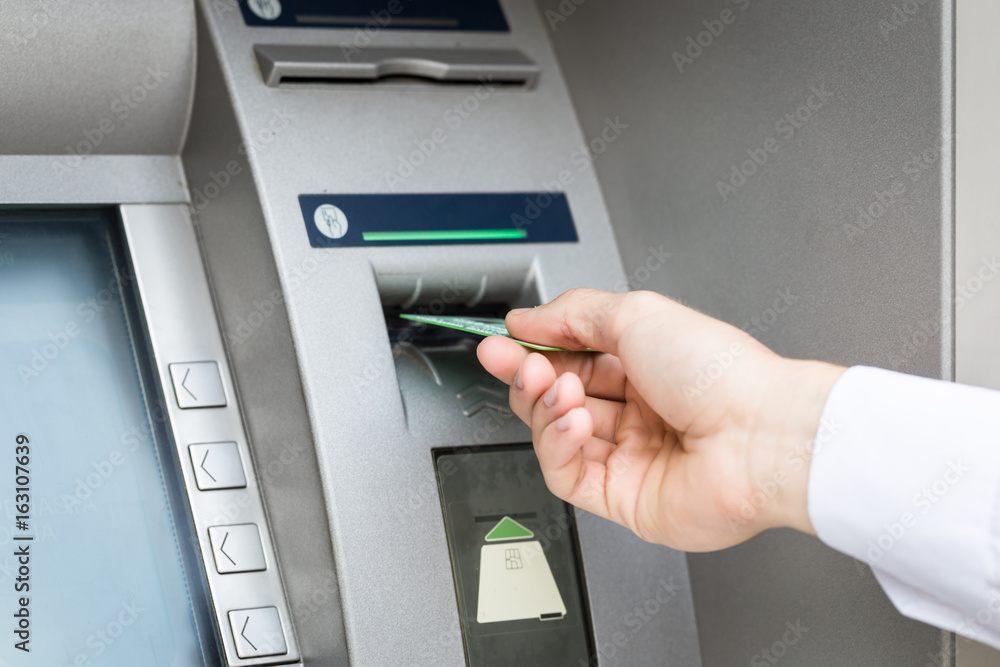 man hand insert credit card to atm man hand insert credit card to atm
