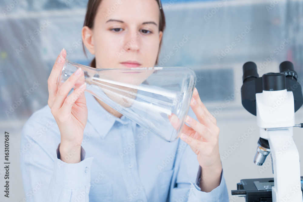 student girl with glass empty Conical flask in hand student girl with glass empty Conical flask in hand