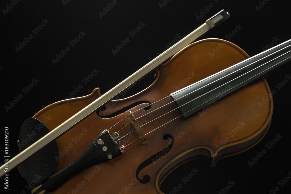 Fototapeta premium Old violin on a black background