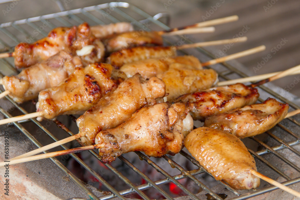 Chicken grilled on charcoal grills