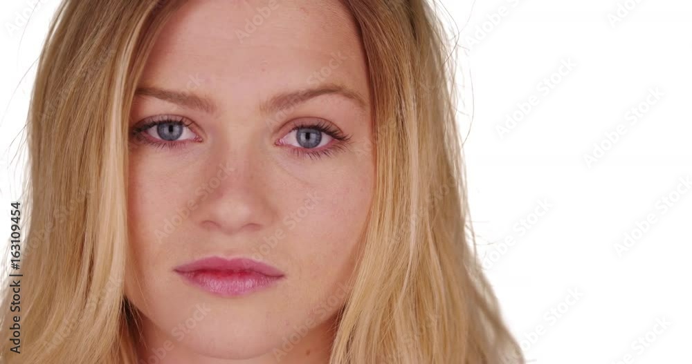 Close up portrait of beautiful blonde woman with blue eyes on white background Close up portrait of beautiful blonde woman with blue eyes on white background