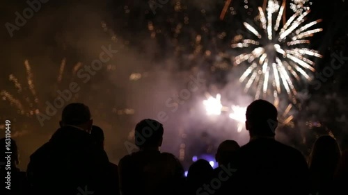 Silhouettes of people watching fireworks
