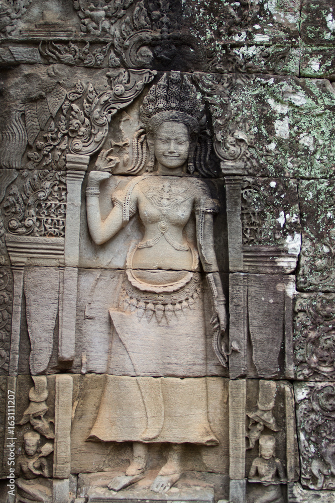 showing dancing Hindu goddesses at Bayon temple, Cambodia.