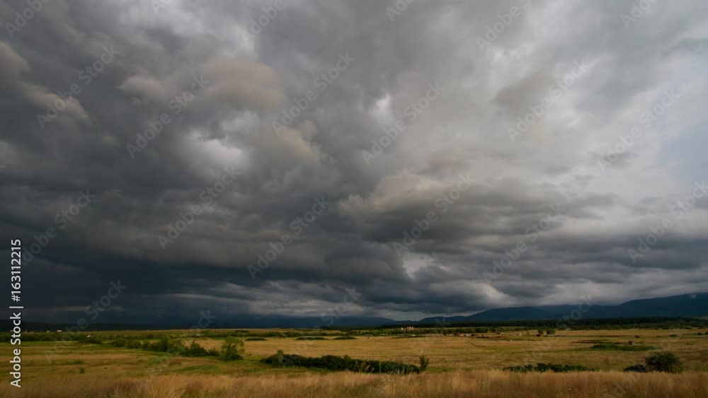 Dramatic clouds over a field. Time lapse shot. Dramatic clouds over a field. Time lapse shot.