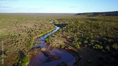 Aerial drone flight over river in uninhabited African nature wilderness