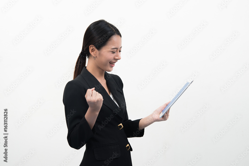 Smiling young business woman uses a tablet PC isolated on white background. Smiling young business woman uses a tablet PC isolated on white background.