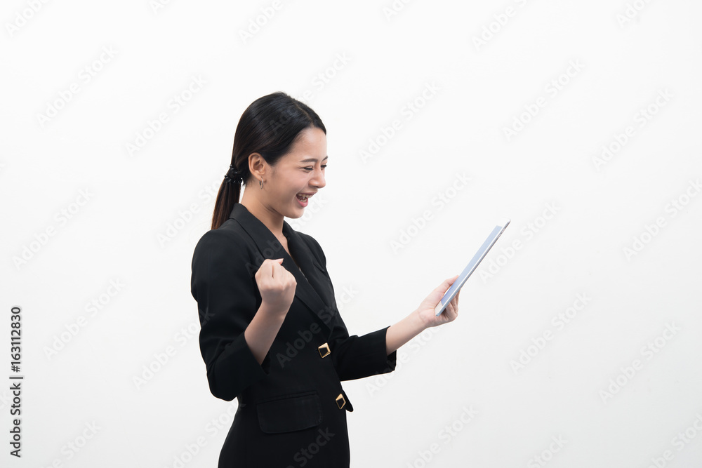 Smiling young business woman uses a tablet PC isolated on white background. Smiling young business woman uses a tablet PC isolated on white background.